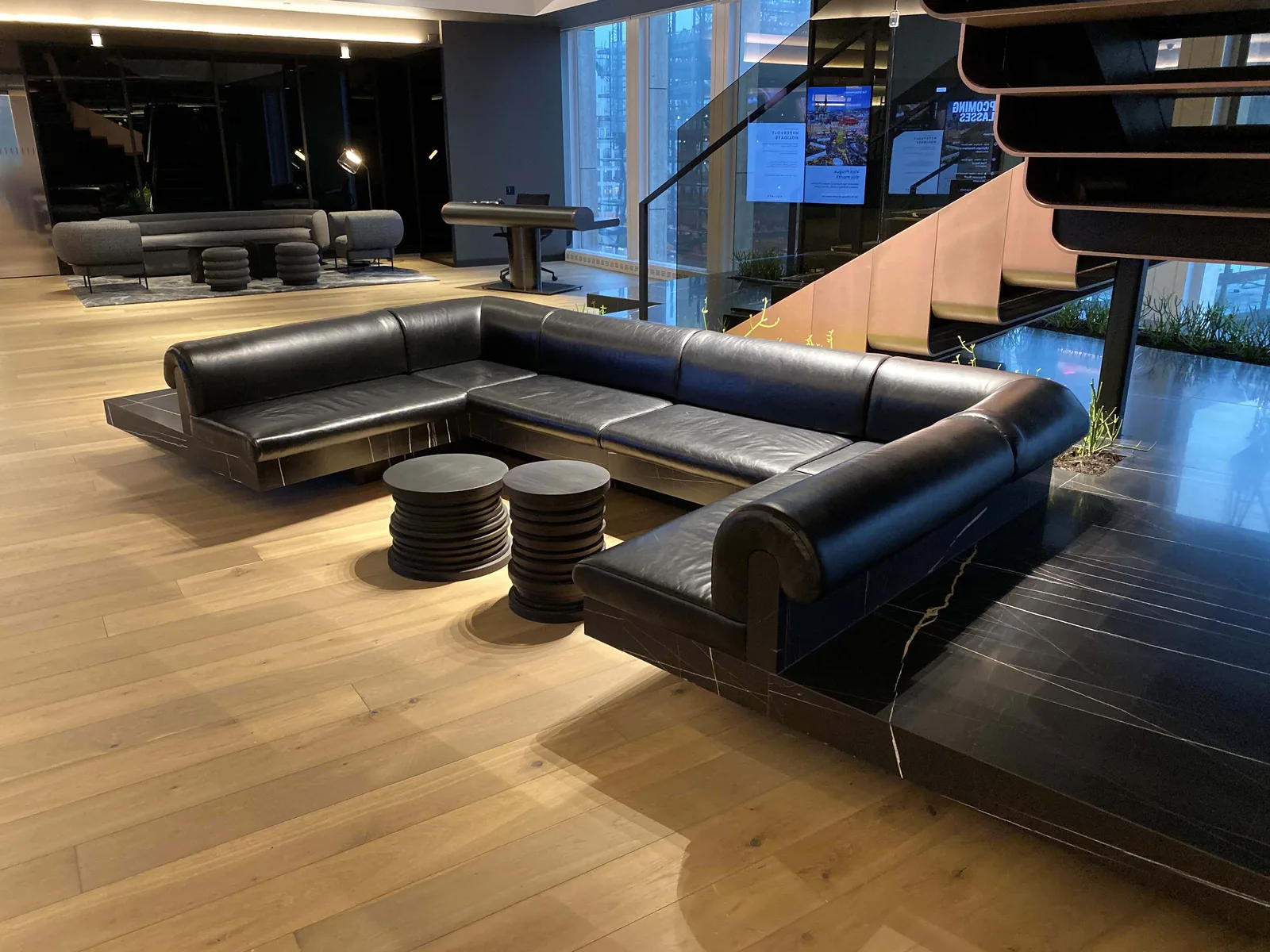 A hotel lounge with a black leather sectional