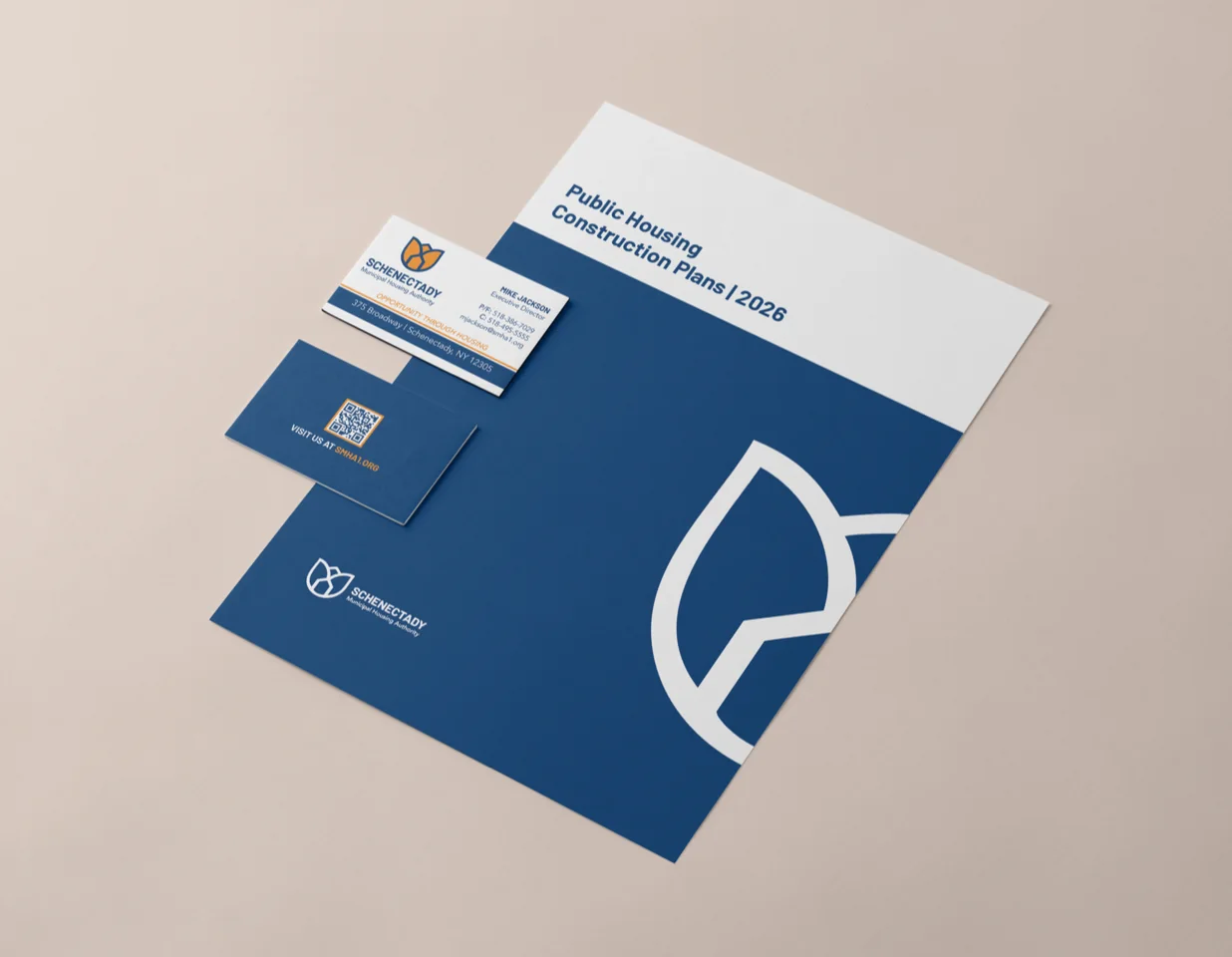 SMHA business cards and a construction plans report in navy and orange